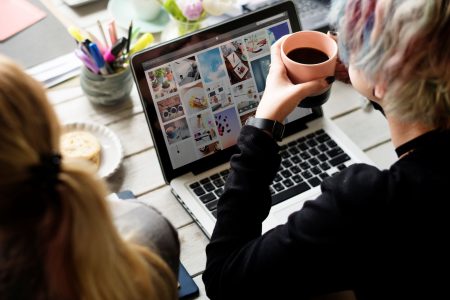 woman-hands-holding-coffee-cup-working-on-laptop-2025-02-10-05-49-13-utc.jpg